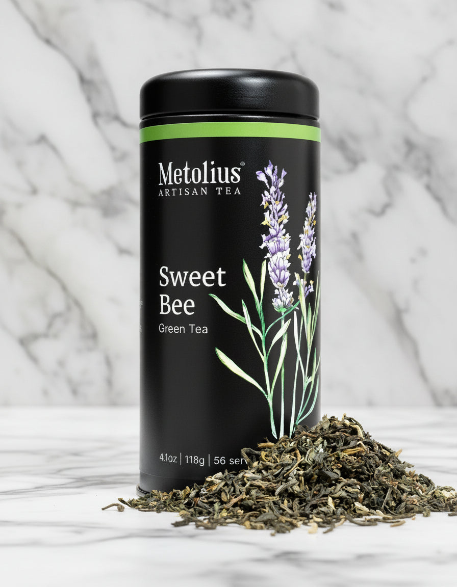Metolius Artisan Tea Sweet Bee Green Tea canister with loose tea leaves on a white background